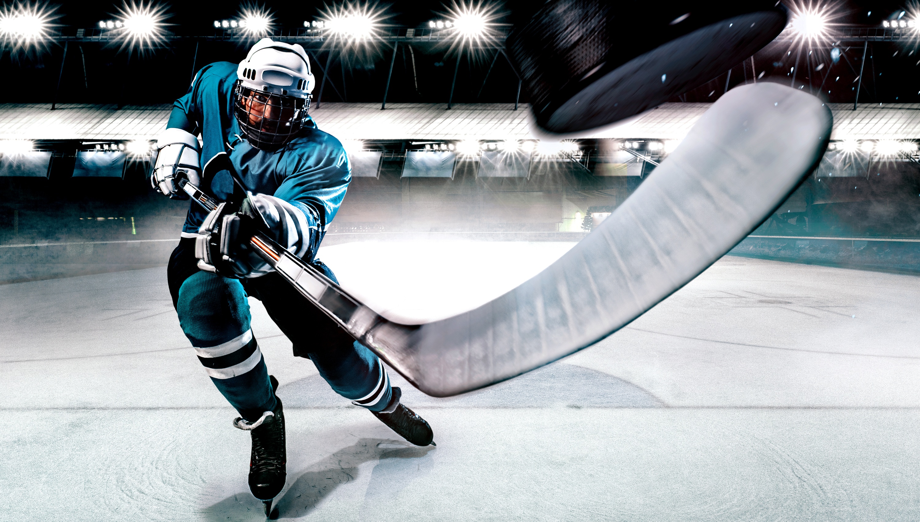 hockey player on the ice - large hockey stick facing towards viewer