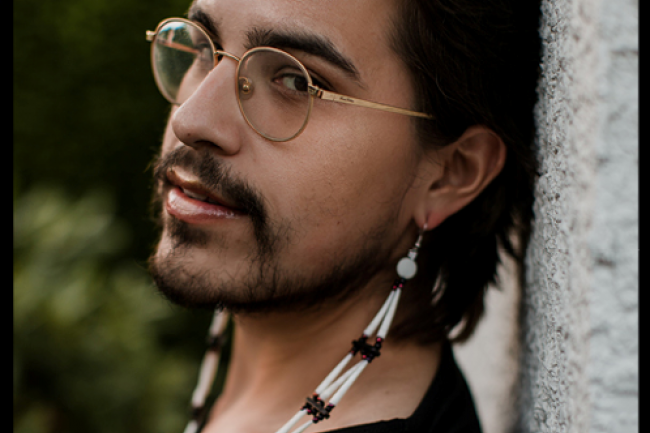 person with glasses and long earrings