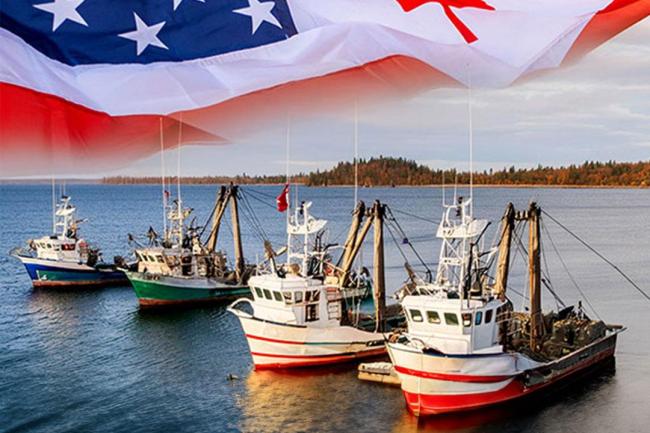 4 fishing vessels with US and Canadian flags in background